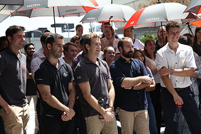 Group of people standing with umbrellas 